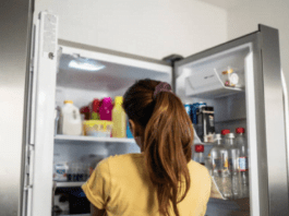 Girl behind a refrigerator